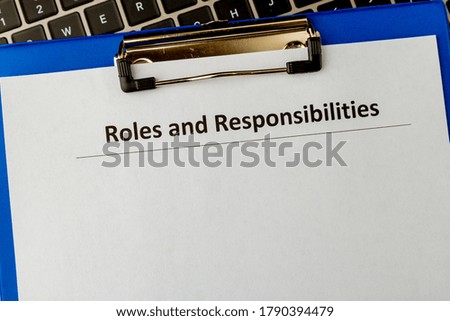 Roles and responsibilities document in the tablet at the laptop on the table.