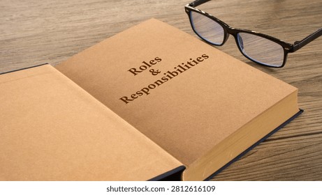 Roles and Responsibilities open book page with glasses