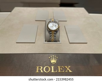 Rolex Emblem Close-up And Rolex Wrist Watch On Showcase. Prague, Czechia - April 2022