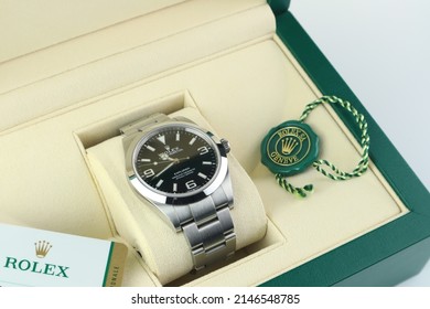 The Rolex vintage wristwatch model oyster perpetual explorer I display in the green leather of Rolex package box with Rolex logo green coin on white table in authorized dealer Rolex shop