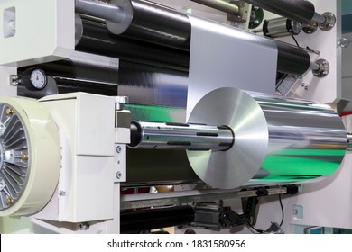 Roll Of Aluminum Foil For Food Packaging On Automatic Packing Machine In Food Product Factory. Industrial And Technology Concept. 