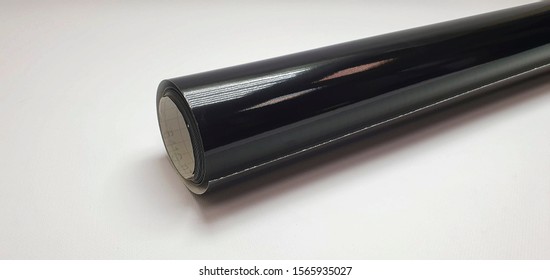 roll of black gloss vinyl film on white background