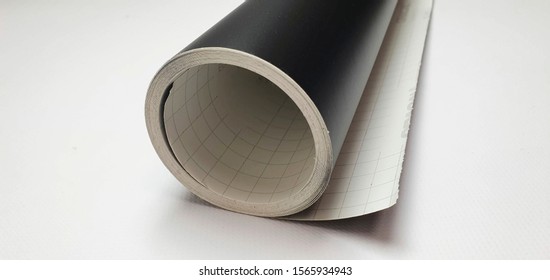 roll of black matte vinyl film on white background