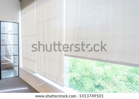 Roll Blinds on the windows, the sun does not penetrate the house. Window in the Interior Roller Blinds. Beautiful Blinds on the Window