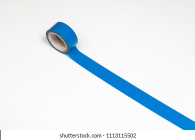 A Roll Of Blue Insulating Tape On A White Surface