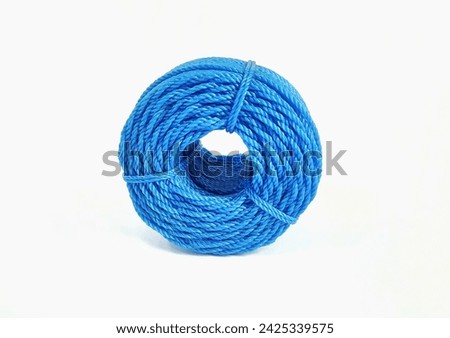 Roll of blue nylon rope isolated on white background with copy space. Clipping path. 