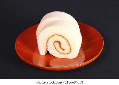 Roll Cake With Lemon Cream On A Plate 