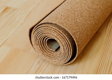 A Roll Of Cork Lies On The Wooden Floor