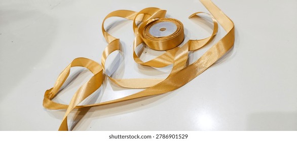 roll of decorative ribbon gift string on white background, image taken from the front position