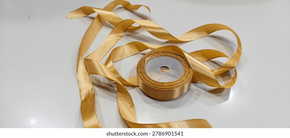 roll of decorative ribbon gift string on white background, image taken from the front position