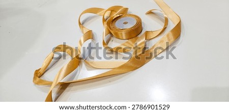 roll of decorative ribbon gift string on white background, image taken from the front position