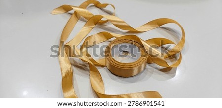 roll of decorative ribbon gift string on white background, image taken from the front position