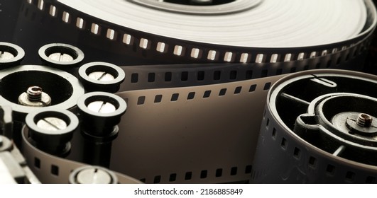 A Roll Of Film In A Film Camera Cassette. Negative Film In The Tape Drive Mechanism Of The Cassette. Show Business Film Production Technology Concept