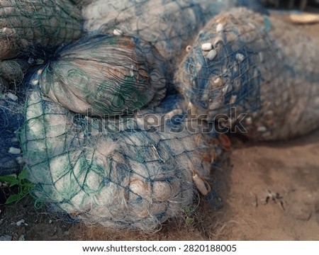 A roll of fishing nets left lying on the edge of the pier.