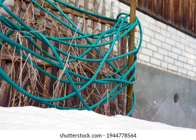 A Roll Of Garden Hose Abandoned Outdoor, Winter Scene