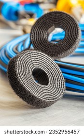 Roll of hook and loop velcro tape used to organize cable in elec