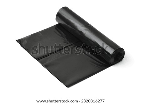 Roll of large black plastic garbage bags isolated on white 