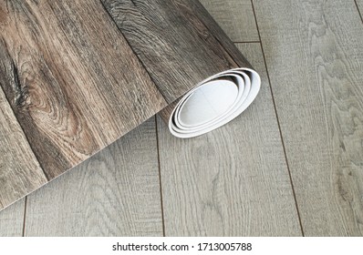 Roll of linoleum with a wood texture. Types of floor coverings. 