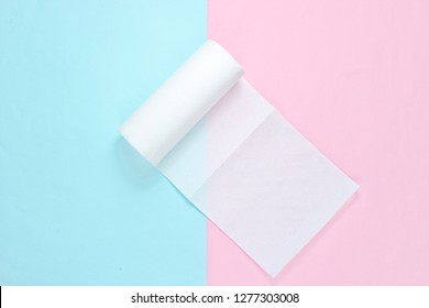 Roll Of Paper Towels On Blue Pink Pastel Background. Minimalism. Top View
 
