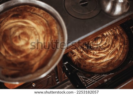 Roll pastry cooked in a wood stove. Turkish Tepsi Boregi, Round Borek, Tray pastry (Turkish name; rulo borek) Stock fotó © 