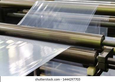 Roll Of Plastic Packaging Film On The Automatic Packing Machine In Food Product Factory. Industrial And Technology Concept. 