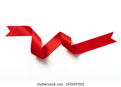 A roll red ribbon isolated on white background - Shutterstock ID 1935597031