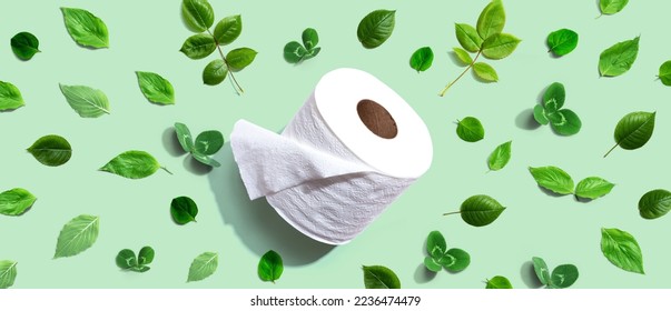 A roll of toilet paper with green leaves - flat lay - Shutterstock ID 2236474479
