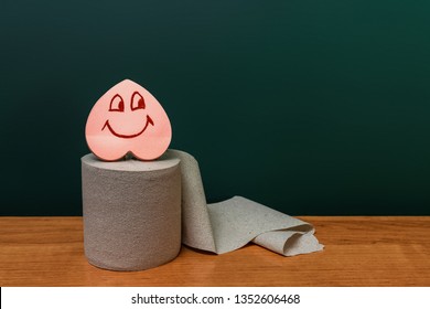 Roll Of Toilet Paper With A Smiling Heart. Digestion Concept.