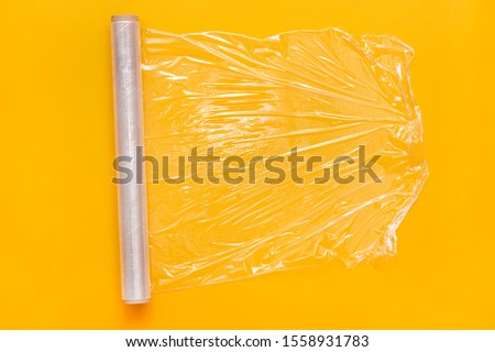 Roll of transparent polyethylene food stretch film for packing products in kitchen. Top view