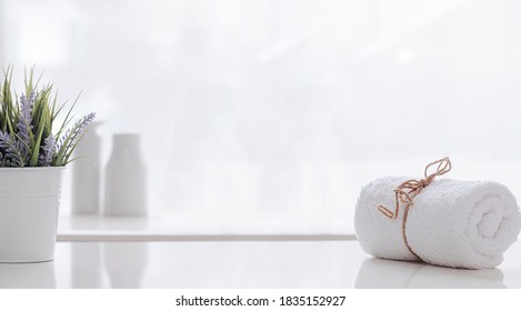 Roll Of White Spa Towel Tied With Hemp Rope On White Counter Table, Copy Space.