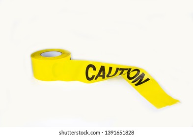 A Roll Of Yellow Caution Tape On A White Background