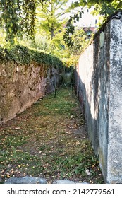 Rolle, Switzerland - September 05 2020 : An Mysterious Looking Back Alley With Walls With Ivy Giving It A Mysterious Look