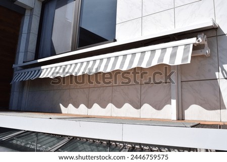 rolled up awning at the wall