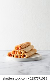 Rolled crepes or thin pancakes on white marble background with copy space. Maslenitsa or Pancake day traditional food concept. Vertical - Shutterstock ID 2257571013
