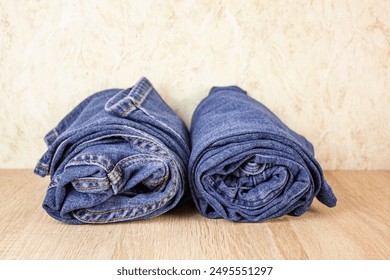 Rolled jeans. Jeans folded, denim pants on the shelf. Jeans in the closet. - Powered by Shutterstock