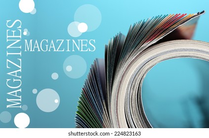 Rolled Up Magazines On Blue Background