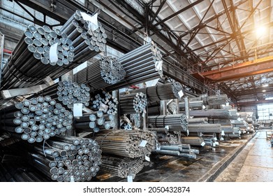 Rolled metal warehouse. Many packs of metal bars on the shelves
