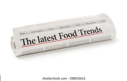 Rolled Newspaper With The Headline The Latest Food Trends