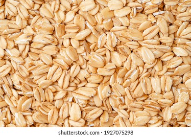 Rolled oat, oat flakes background or texture. Close up, directly above. - Shutterstock ID 1927075298