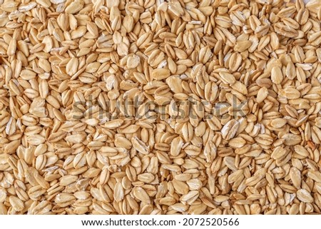Rolled oat, oat flakes background or texture. Close up, directly above.Heap of dry rolled oats isolated.