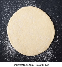 Rolled Out Pizza Dough On Floured Slate Surface, Photographed Overhead With Natural Light