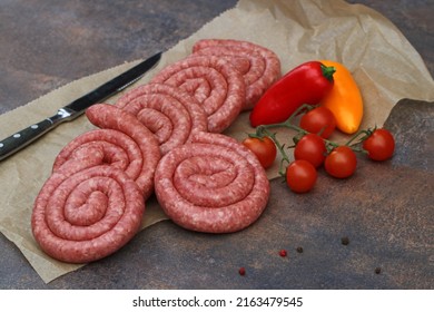 Rolled sausages with tomatoes and peppers.