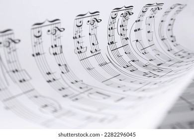 Rolled sheet with music notes, closeup view
