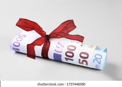 Rolled Twenty to Five Hundred Euro Banknotes with Red Ribbon