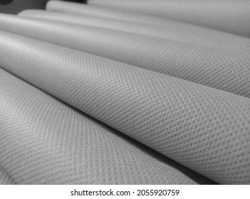 rolled white polypropylene fabric. non-woven fabric with a fibrous texture. industrial bag material