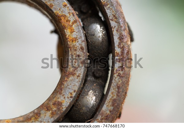 roller\
bearings. A piece of old engine car spare part. Rusty iron surface.\
The rust on steel Texture. Decay metal\
object.