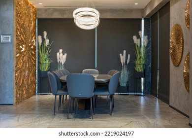 Roller blinds in the interior. Automatic blackout shades large size on the windows. Modern interior with wood decor panels on the wall. Plants in hi-tech flower pots. Electric curtains for home.
