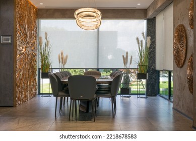 Roller blinds in the interior. Automatic solar shades large size on the windows. Modern interior with wood decor panels on walls. Plants in hi-tech flower pots. Electric sunscreen curtains for home.  - Shutterstock ID 2218678583