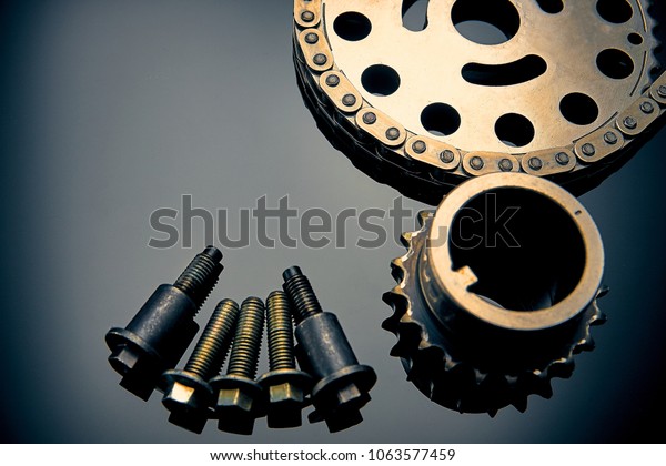 Roller chain with sprocket on dark\
background. It is used on cars, motorcycles, bicycles and in\
mechanical engineering. Can be used as a\
background
