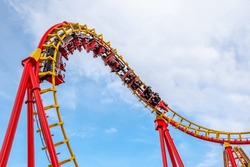 A Roller Coaster In Action At An Amusement Park
